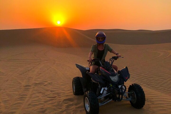Experience the beauty of the desert at sunrise riding a quad bike through golden sands tailored to your skill level while discovering the serene landscapes and unique wildlife of Dubai.
